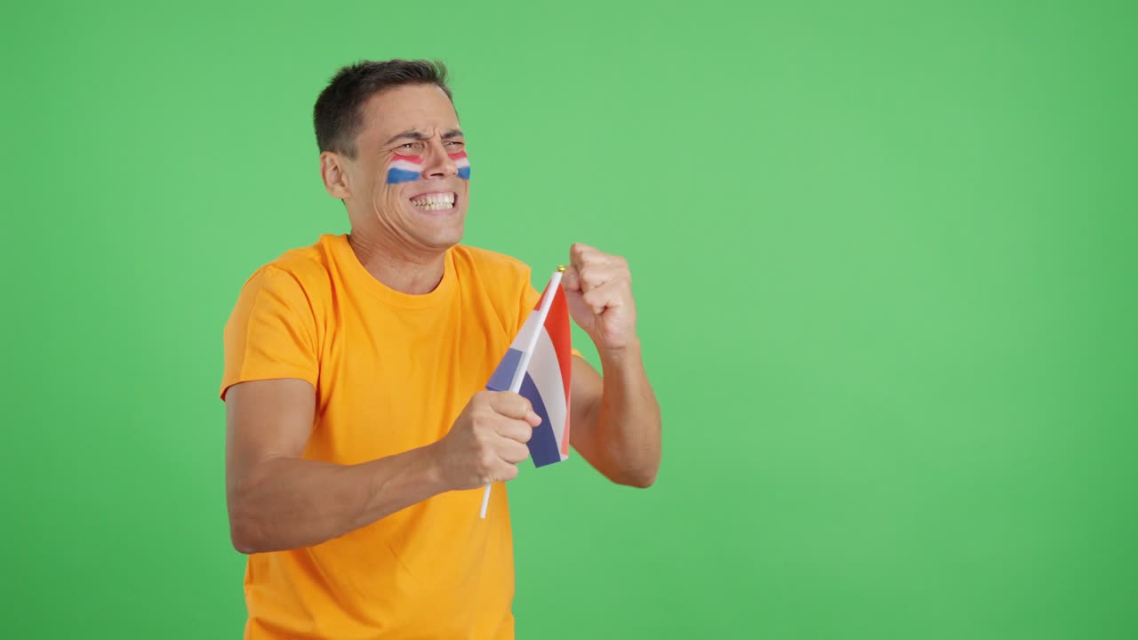 Nervous man cheering for Holland during a match looking away