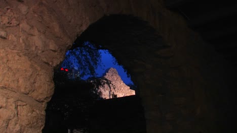 A-stone-wall-is-seen-through-a-brick-archway-in-San-Antonio-Texas-1