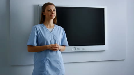 a healthcare professional standing in front of a blank screen