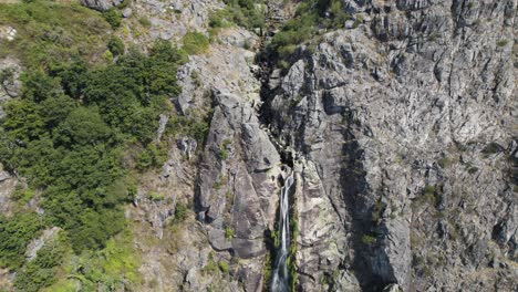 aerial top-down view of big natural waterfall named "frecha da mizarela" at serra da freita