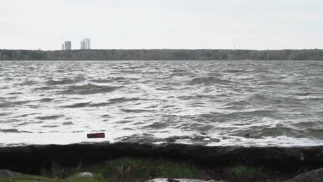 lake with waves and cityscape