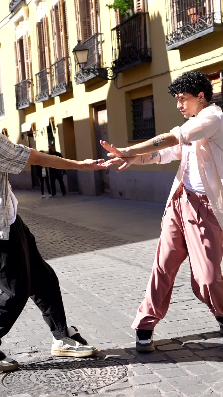 Two men dancing on a city street