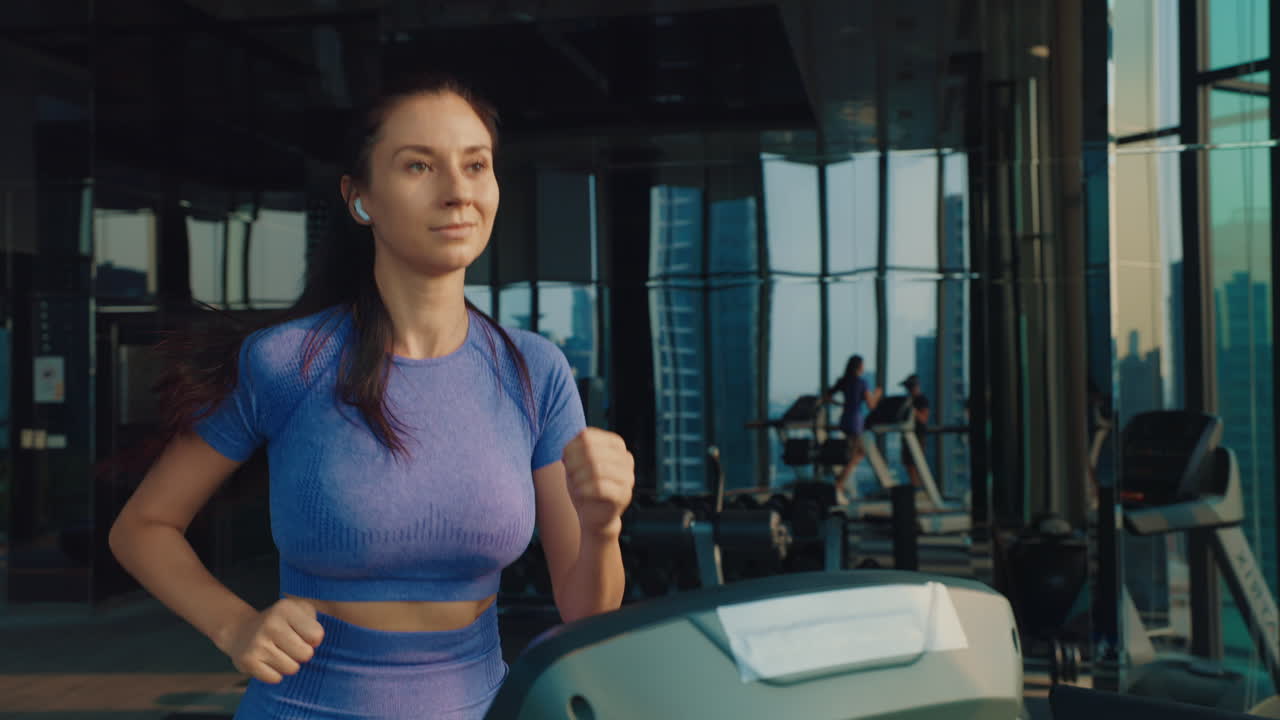 Woman Running on Treadmill in a Modern Gym