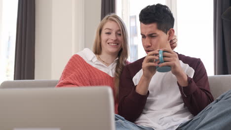 portrait of a young couple on a video call with their laptop while staying at home.