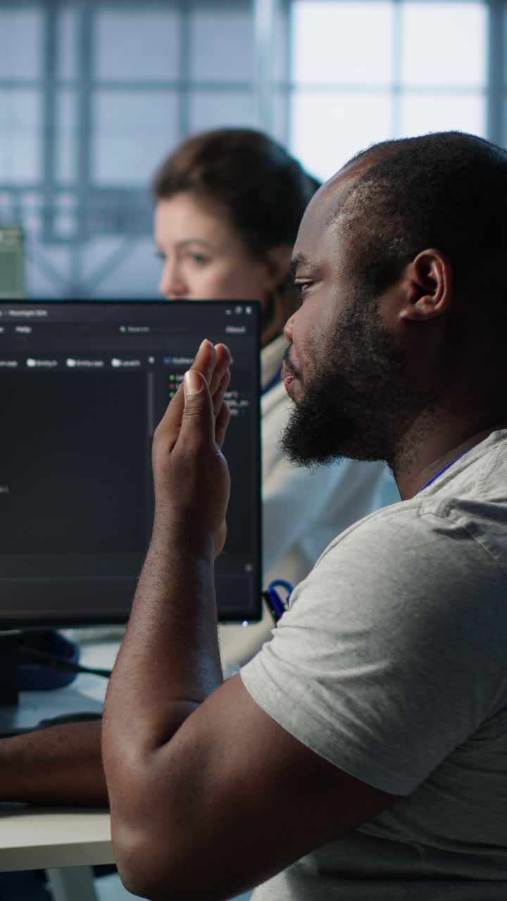 African American Programmer Yawning and Feeling Tired at Office Desk