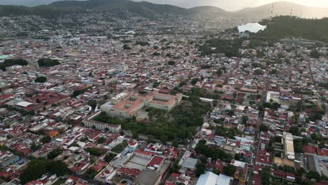 Santo-Domingo-centerpiece,-aerial-exploration-of-Oaxaca-City-amidst-mountains