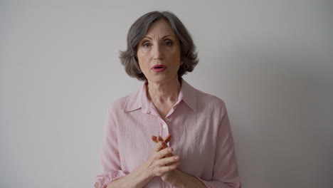 Shocked-Mature-Woman-Looking-At-Camera-On-White-Background