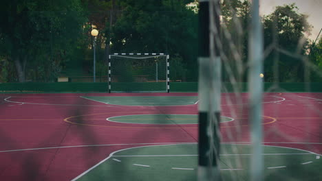 outdoor-court-behind-the-goal-fence-point-of-view-slow-motion