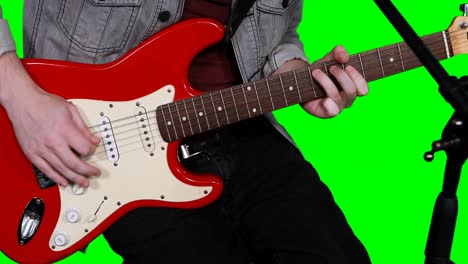mid section of male musician playing guitar