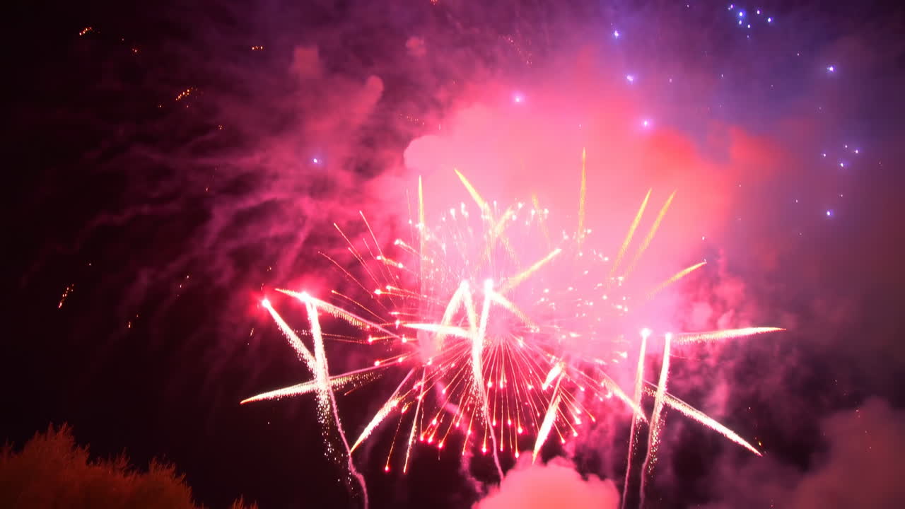 Night Sky Fireworks Display With Vivid Blue And Pink Explosions, Cascading Golden Spark Trails, Rising Smoke