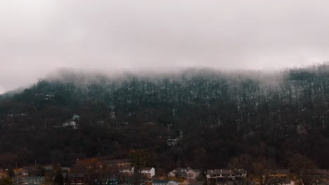 A-thick-fog-covering-a-mountain-range-in-the-middle-of-springtime