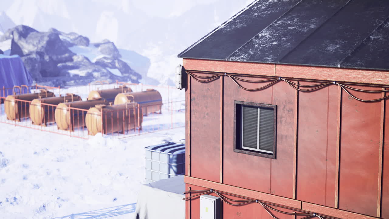 Structures amid snowy mountains in a cold remote location