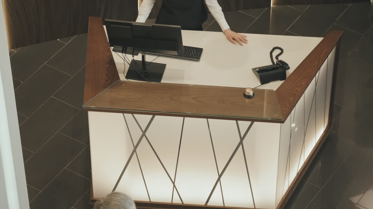 Top-View of Couple Checking-In at Reception Desk