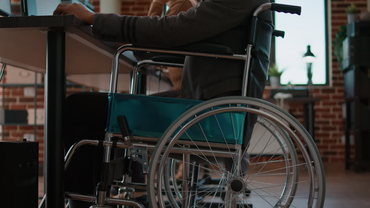 African american man in wheelchair using headset on phone line