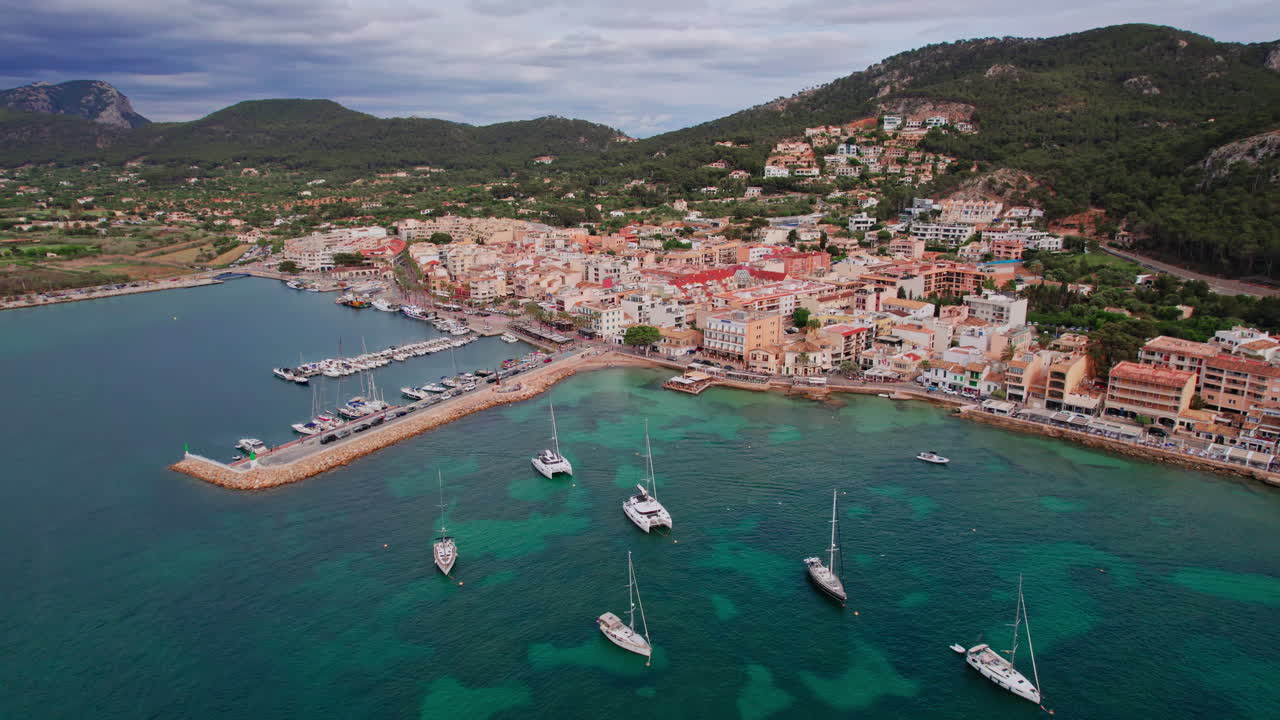 Wide establishing aerial over yachts in the marina of the famous Port d'Andratx harbor on the island of Mallorca, Spain, a popular Mediterranean vacation destination for sailing, fishing and dining