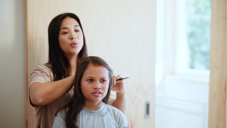 brushing hair, bond or mother