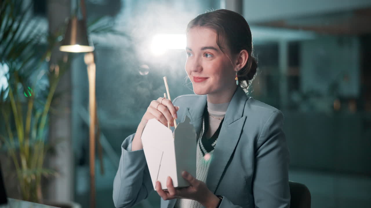 Woman Eating Takeout Noodles in Office
