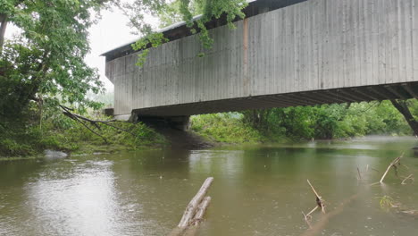 Low-Angle-View:-Rain-Drenched-Covered-Bridge-Shrouded-in-Clouds-and-Mist,-Gates-Farm-Covered-Bridge