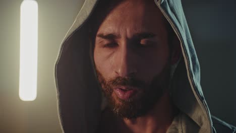 close-up portrait of a man wearing a hoodie