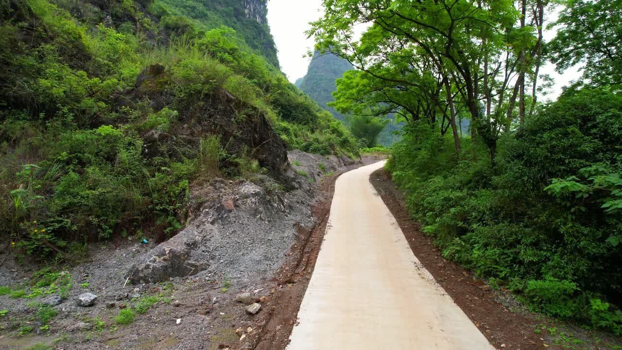 Scenic Path Through Lush Green Mountains