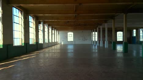 wide shot, moving backwards, showing a belfast spinning mill warehouse in northern ireland