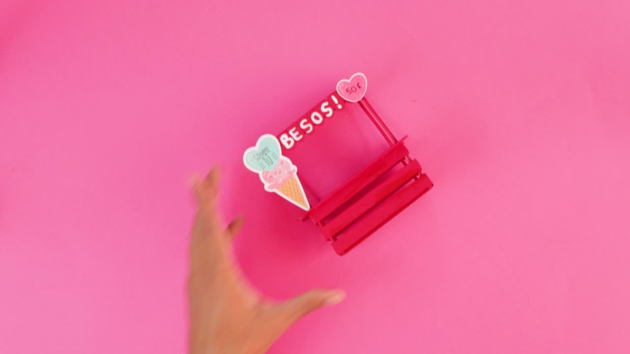 Painting miniature kissing booth from popsicle sticks for Valentine.