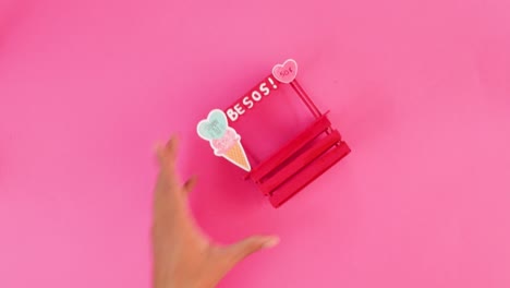 painting miniature kissing booth from popsicle sticks for valentine.