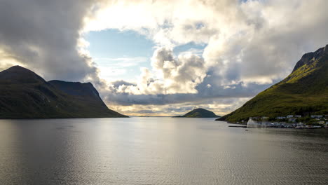 lake between mountains under a sky with clouds