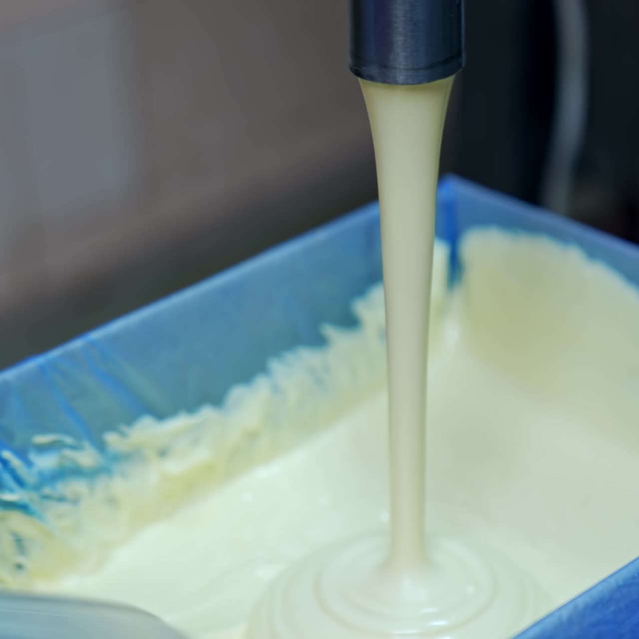 Butter in production line. Close up of butter industry process