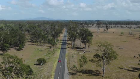 isolated car driving on deserted road in rural landscape, bajool