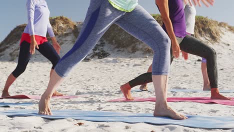 Mujeres-Atléticas-Realizando-Yoga-En-La-Playa