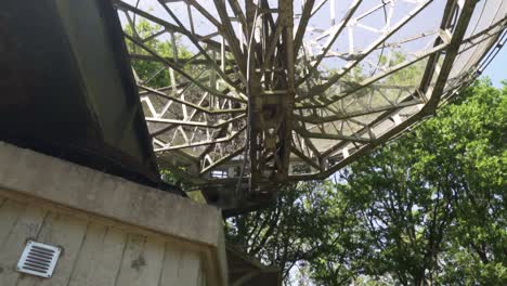 old abandoned radar antenna in a forest