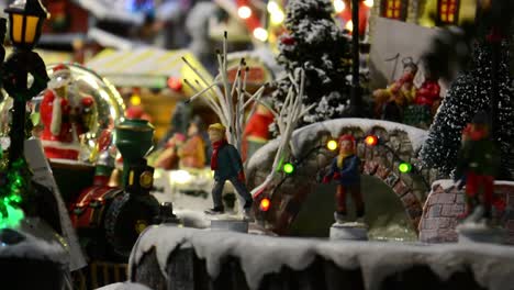 christmas toys, snowball, carousel and ice rollerblading toys with multi-colored lights in a christmas market