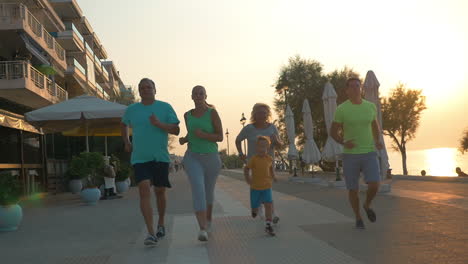 happy family finishing evening run on resort