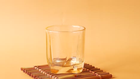 orange juice being poured into a glass