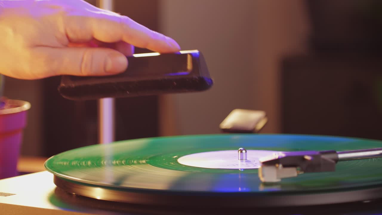Retro Vinyl record player playing music, close-up macro shot of vintage LP disc old phonograph spinning. Retro music player.