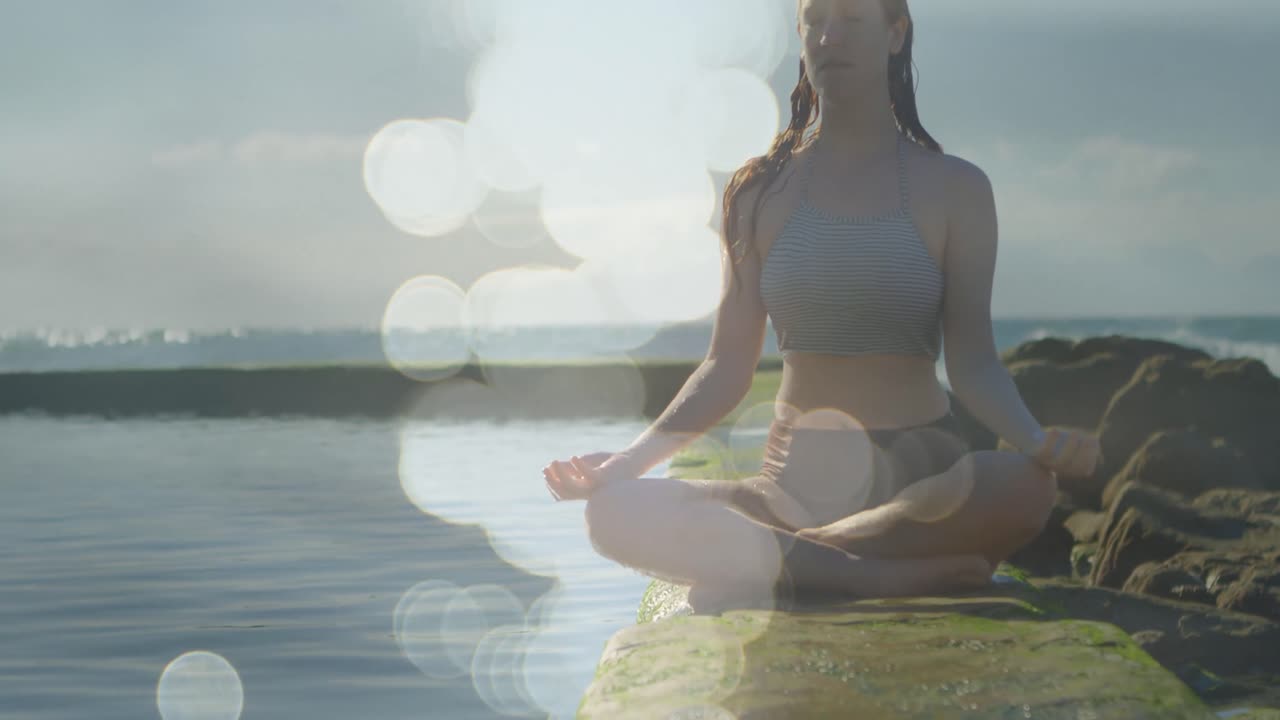 animación de puntos de luz sobre una mujer caucásica practicando yoga y meditando