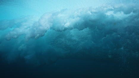 underwater view of a powerful breaking wave