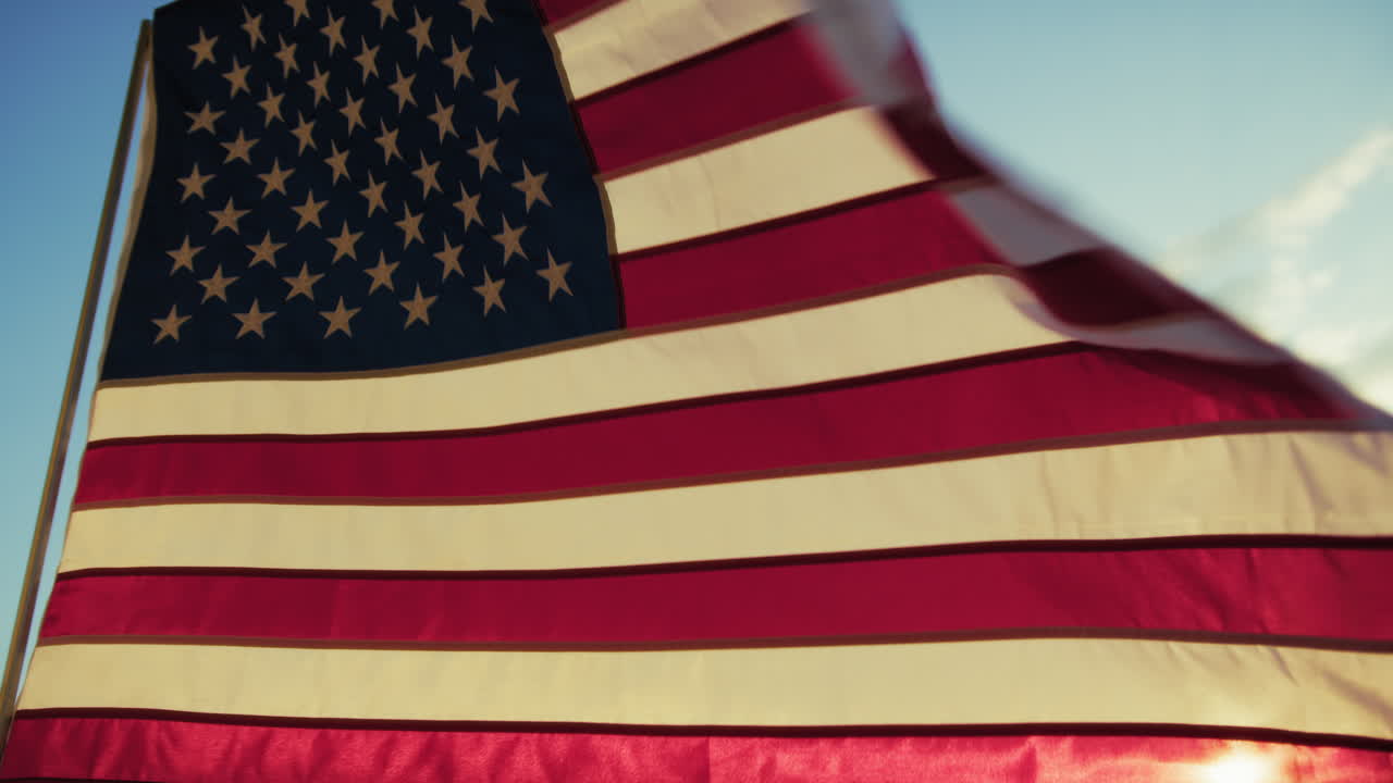 American Flag Waving At Sunset Sky On Memorial Day Holiday