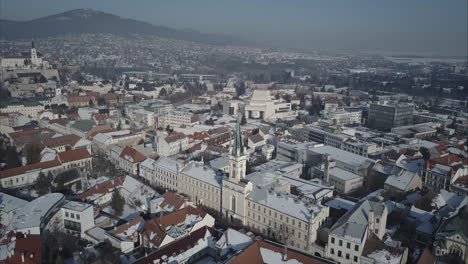 toma aérea amplia de la ciudad de nitra con castillo y montañas en el fondo, invierno, eslovaquia