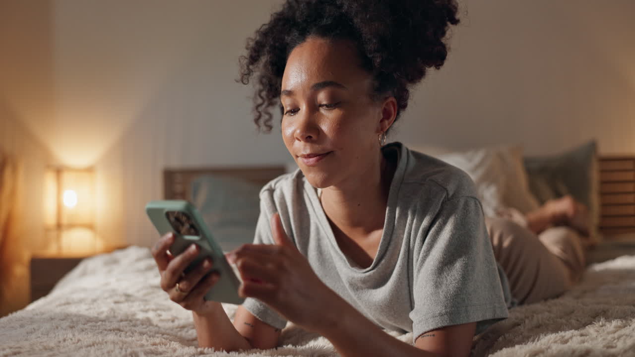 Woman Relaxing in Bed Using Smartphone