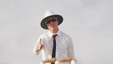 cricket umpire making signs standing on a cricket pitch