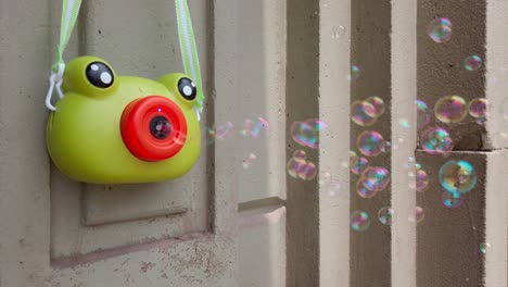 static close-up of frog-shaped toy emitting bubbles on a sunny day in oaxaca