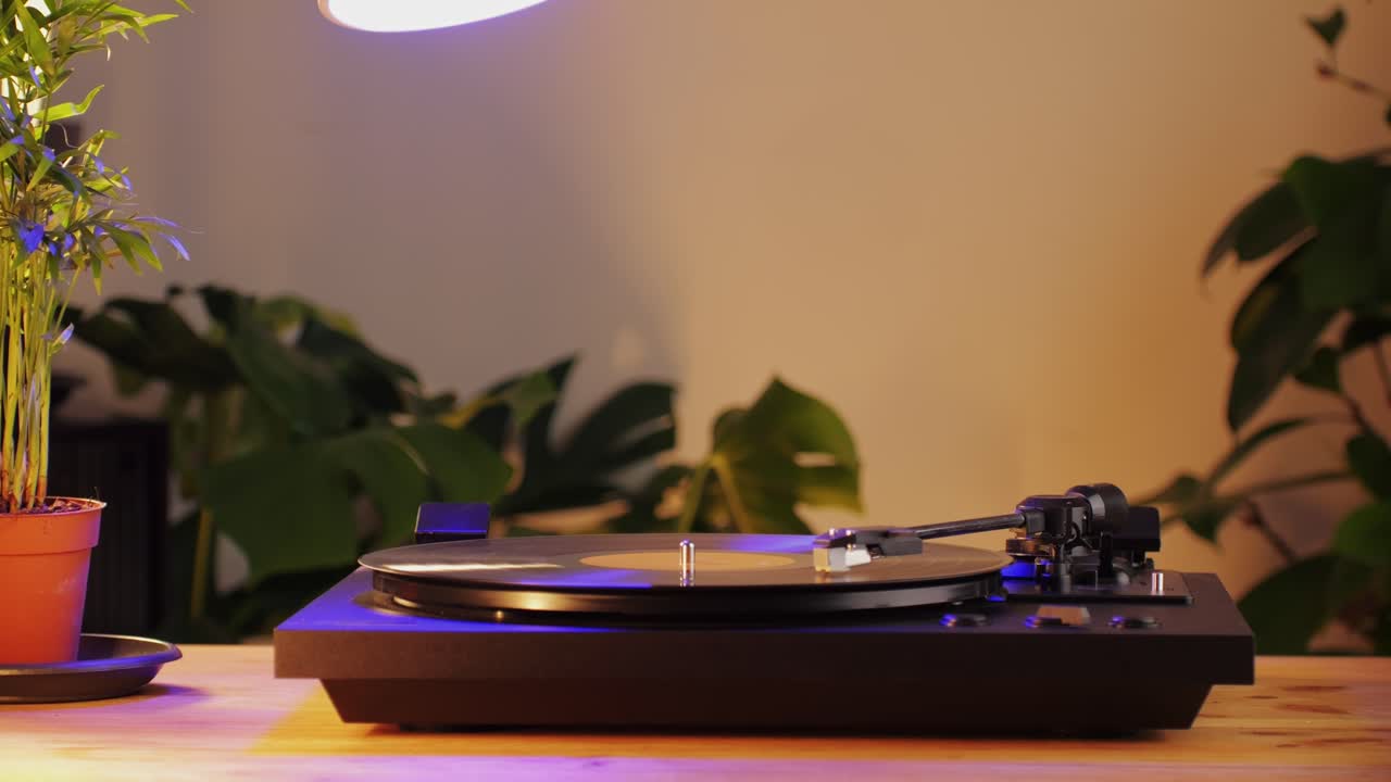 Retro Vinyl record player playing music, close-up macro shot of vintage LP disc old phonograph spinning. Retro music player.