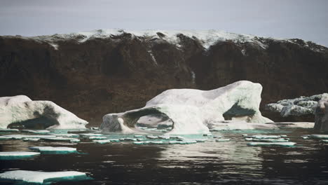 gigantic ice block structures on the black sand by the sea shore