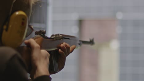 shooter firing the m1 carbine at a firing range in slow motion