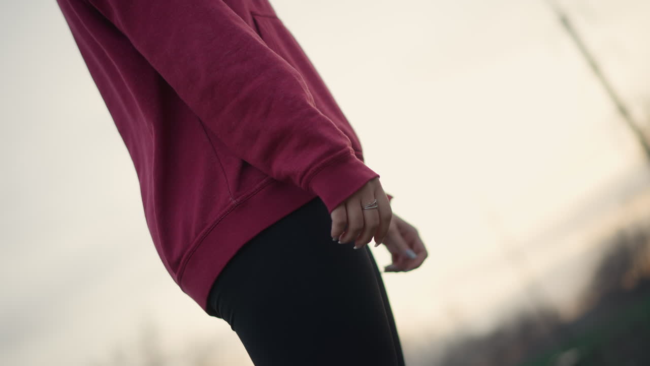Evening Stretching Session, Twilight Workout Emphasizing Flexibility And Deep Breathing, Sunset Fitness Routine Involving Arm Stretches With Resistance Band And Tranquil Urban Scenery In Background