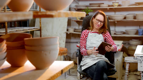 female potter using digital tablet 4k