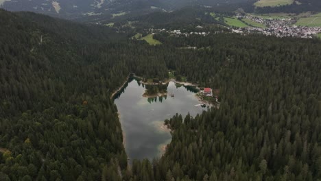 aerial view of a serene alpine lake surrounded by lush green forest