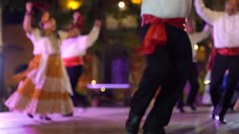 shallow depth of field showing man and woman doing mexican dance in background